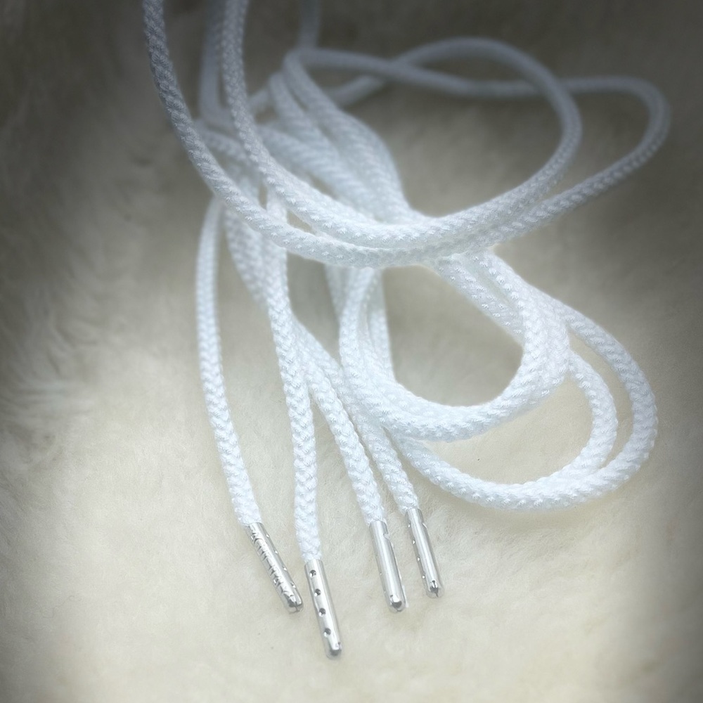 A pair of rope shoelaces with silver tips